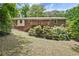 View of a house with a deck and landscaped backyard featuring grass and natural foliage at 3327 Spring Meadow Ct, Tucker, GA 30084