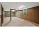 Spacious basement featuring wood-paneled walls, carpeted floors, and natural light from windows at 3327 Spring Meadow Ct, Tucker, GA 30084