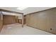 Large basement with carpeted floor, support beam, and access to the upper level via a stairway at 3327 Spring Meadow Ct, Tucker, GA 30084