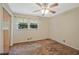 Cozy bedroom featuring a ceiling fan, closet, and window providing natural light at 3327 Spring Meadow Ct, Tucker, GA 30084