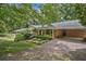 Charming brick home with covered parking, landscaped yard, and mature trees provides comfortable living at 3327 Spring Meadow Ct, Tucker, GA 30084