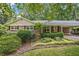Inviting brick home with black shutters and mature landscaping exudes classic charm and curb appeal at 3327 Spring Meadow Ct, Tucker, GA 30084