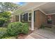 Charming brick home featuring a covered front porch with manicured landscaping at 3327 Spring Meadow Ct, Tucker, GA 30084