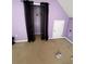 Bedroom featuring neutral carpet, lilac-painted walls, and a closet with black curtains at 384 Daniel Mill Xing, Villa Rica, GA 30180