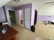 Spacious bedroom with neutral carpet, lilac-painted walls, and multiple access doorways at 384 Daniel Mill Xing, Villa Rica, GA 30180