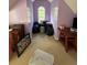 Attic bedroom with a bright window, lilac-painted walls, and neutral carpet at 384 Daniel Mill Xing, Villa Rica, GA 30180