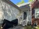 Charming entrance featuring a partial brick facade, complemented by stairs and railings at 384 Daniel Mill Xing, Villa Rica, GA 30180