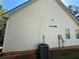 Home exterior featuring light siding, a green lawn, and an air conditioning unit at 384 Daniel Mill Xing, Villa Rica, GA 30180