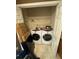 Laundry closet featuring washer, dryer, and overhead shelving for convenient and organized laundry space at 384 Daniel Mill Xing, Villa Rica, GA 30180