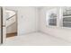 Bright bedroom includes neutral carpet, white walls, natural light, and stairs outside the door at 621 Broadview Ne Ter, Atlanta, GA 30324