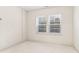 Bright bedroom with neutral carpet, white walls, and natural light from a window at 621 Broadview Ne Ter, Atlanta, GA 30324