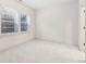 Bedroom features neutral carpet, white walls, and natural light from a window at 621 Broadview Ne Ter, Atlanta, GA 30324