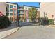 Gated entrance to building with red brick and beige siding on a sunny day and secure entry at 621 Broadview Ne Ter, Atlanta, GA 30324