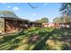 This backyard is spacious and green, with a brick house and other yard structures visible at 6418 Briarwood Ct, Riverdale, GA 30296