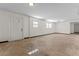 Finished basement offering an exterior door, windows and white paint at 6418 Briarwood Ct, Riverdale, GA 30296