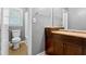 Bathroom showcasing cherry vanity, new tile, white tile and modern toilet at 6418 Briarwood Ct, Riverdale, GA 30296