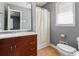 Bathroom featuring a cherry vanity, white tile, large mirror and shower at 6418 Briarwood Ct, Riverdale, GA 30296