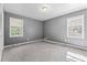 Bedroom offering neutral walls, carpet and ample natural light from two windows at 6418 Briarwood Ct, Riverdale, GA 30296