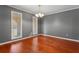 Classic dining room with hardwood floors, crown molding, and a charming chandelier at 6418 Briarwood Ct, Riverdale, GA 30296