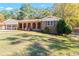Well-maintained brick home with an arched brick porch and a lush, green front lawn at 6418 Briarwood Ct, Riverdale, GA 30296