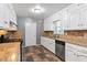Classic kitchen with granite countertops, white cabinets and stainless-steel dishwasher at 6418 Briarwood Ct, Riverdale, GA 30296
