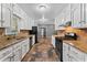Efficient kitchen layout featuring white cabinets, granite countertops, and ample counter space at 6418 Briarwood Ct, Riverdale, GA 30296