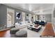 Virtually staged living room with lots of natural light, hardwood floors, and a neutral color palette at 6418 Briarwood Ct, Riverdale, GA 30296