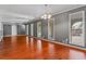 Spacious living room with hardwood floors and abundant natural light from multiple windows at 6418 Briarwood Ct, Riverdale, GA 30296
