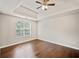 Bedroom with hardwood floors, tray ceiling, fan, and natural light from window at 2240 Creekside Vw, Decatur, GA 30035