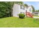 Side view of a two-story home featuring green grass, a neat bush, and red stairs at 2240 Creekside Vw, Decatur, GA 30035