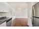 Bright kitchen features stainless steel appliances, granite counters, and hardwood floors at 2240 Creekside Vw, Decatur, GA 30035