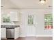 Bright kitchen with stainless steel dishwasher, wood floors, and window view at 2240 Creekside Vw, Decatur, GA 30035