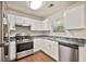 Modern kitchen featuring stainless steel appliances, white cabinets, and dark countertops at 2240 Creekside Vw, Decatur, GA 30035