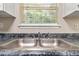 Close-up of kitchen sink area with double basin and window with outdoor view at 2240 Creekside Vw, Decatur, GA 30035