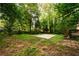 This sprawling backyard has a patio, lush lawn, mature trees, and a deck, creating an outdoor oasis at 4324 Japonica Sw Ct, Lilburn, GA 30047