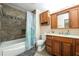 Bathroom featuring a tub and shower combination, vanity, tile flooring, and great lighting at 4324 Japonica Sw Ct, Lilburn, GA 30047