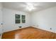 Bright bedroom offering hardwood floors, white trim, a ceiling fan, and ample natural light at 4324 Japonica Sw Ct, Lilburn, GA 30047