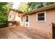 A charming deck offers outdoor living space with a view of the home's exterior and wooded surroundings at 4324 Japonica Sw Ct, Lilburn, GA 30047