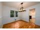 Cozy dining room with wood floors, wainscoting, and a modern light fixture at 4324 Japonica Sw Ct, Lilburn, GA 30047