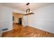 Well-lit dining room with wood floors and an open view into the living room at 4324 Japonica Sw Ct, Lilburn, GA 30047