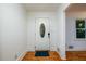 Bright entryway featuring wood floors, white trim, and a front door with decorative glass window at 4324 Japonica Sw Ct, Lilburn, GA 30047