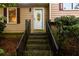 Stairway leading to the front door with a decorative glass window at 4324 Japonica Sw Ct, Lilburn, GA 30047