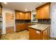 Charming kitchen featuring granite countertops, wood cabinets, and modern tile flooring at 4324 Japonica Sw Ct, Lilburn, GA 30047