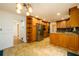 Spacious kitchen and dining area featuring wood cabinetry, granite countertops, and stainless appliances at 4324 Japonica Sw Ct, Lilburn, GA 30047