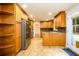 Well-equipped kitchen featuring wooden cabinetry, stainless steel appliances, and tiled floors at 4324 Japonica Sw Ct, Lilburn, GA 30047