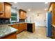 Bright kitchen showcasing granite counters, stainless sink, dishwasher, and tile floor at 4324 Japonica Sw Ct, Lilburn, GA 30047