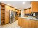 Spacious kitchen with stainless steel appliances, granite countertops, and ample wooden cabinet space at 4324 Japonica Sw Ct, Lilburn, GA 30047