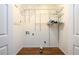 A functional laundry room is equipped with open shelving for storage and washer/dryer hookups at 4324 Japonica Sw Ct, Lilburn, GA 30047