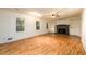 Spacious living room with wood floors, built-in shelving, a fireplace, and large windows at 4324 Japonica Sw Ct, Lilburn, GA 30047