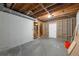 Unfinished basement with exposed wooden ceiling beams, concrete floor and door to upper level at 4408 Brandon Ne Ct, Marietta, GA 30066